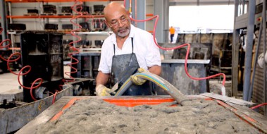 Man pouring GRC into a mould for GRC manufacturing